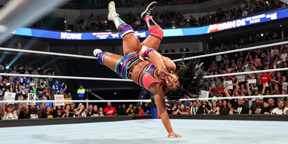 Roxanne Perez executing a high-flying wrestling move in an electrifying wrestling match.
